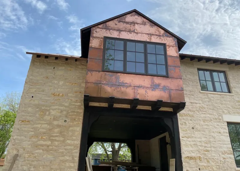 Copper metal panel facade on a stone building for Skylight Installation in North Hills