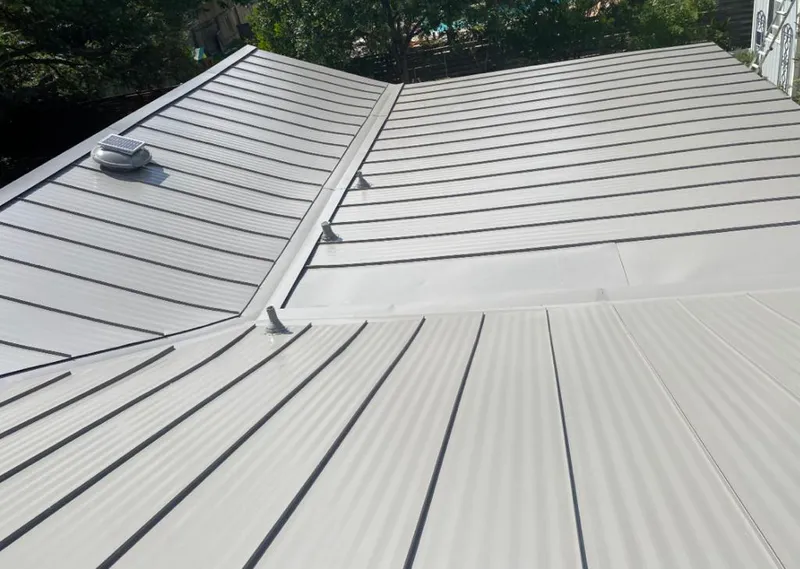 Solar attic fan installed on a metal roof for Roof Ventilation in North Hills