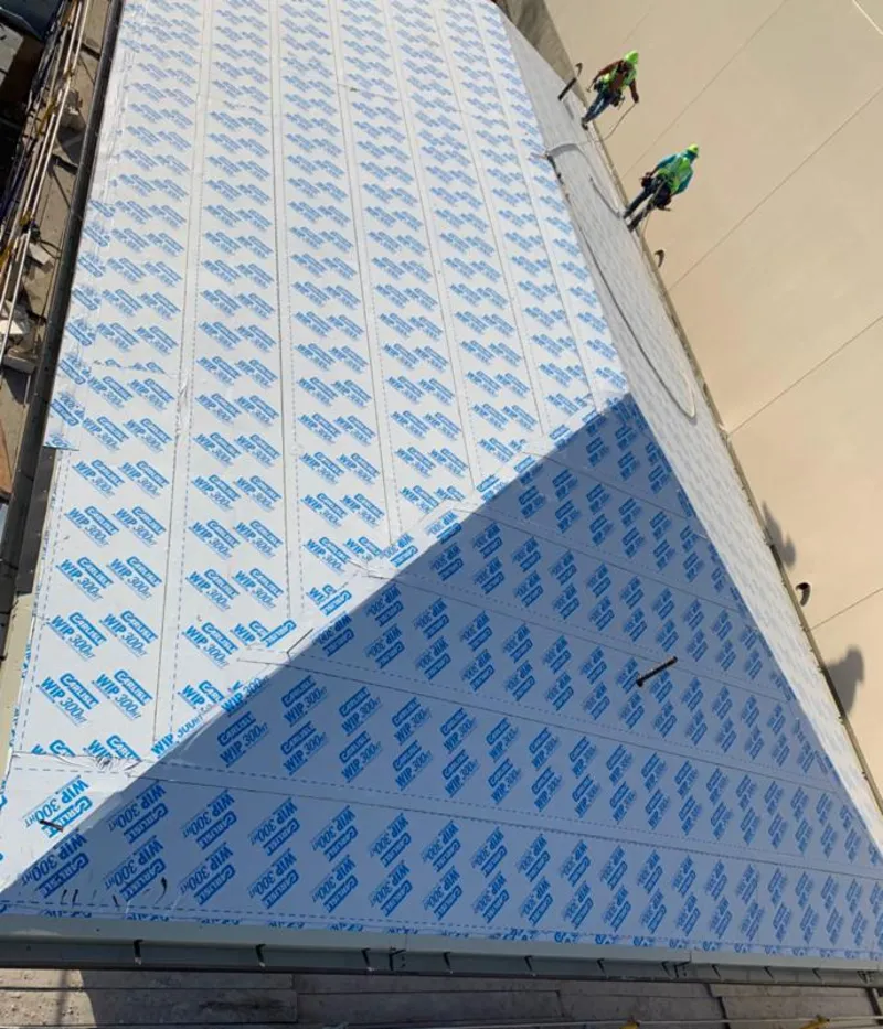 Professional roofers installing underlayment on a metal roof in North Hills